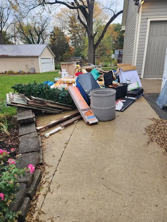 Dumpster being loaded with debris for Estate Cleanout Dumpster Rental in North Sioux City